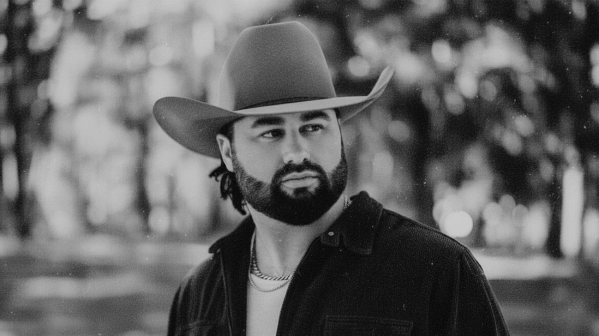 Koe Wetzel in a cowboy hat outside with a grainy texture filter