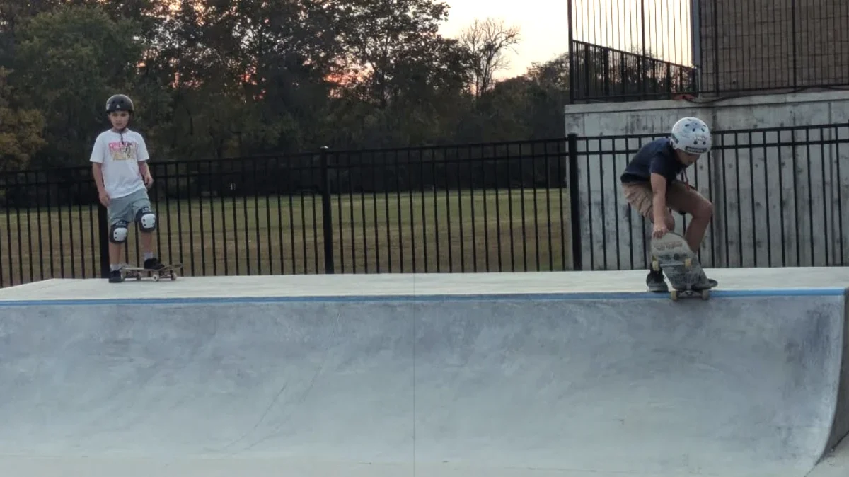 Two teens enjoying a ramp at the Alex LeVasseur Memorial Skatepark
