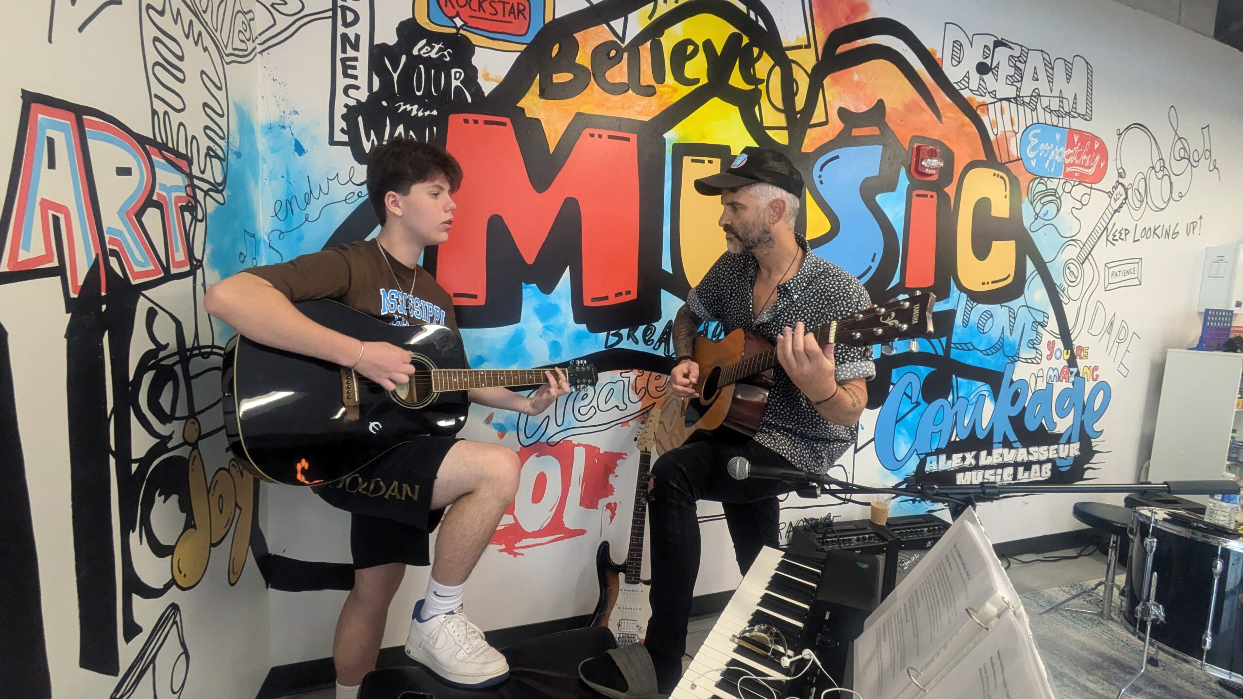 A young adult receives hands on musical experience during Music Mondays at Brentwood Family YMCA.