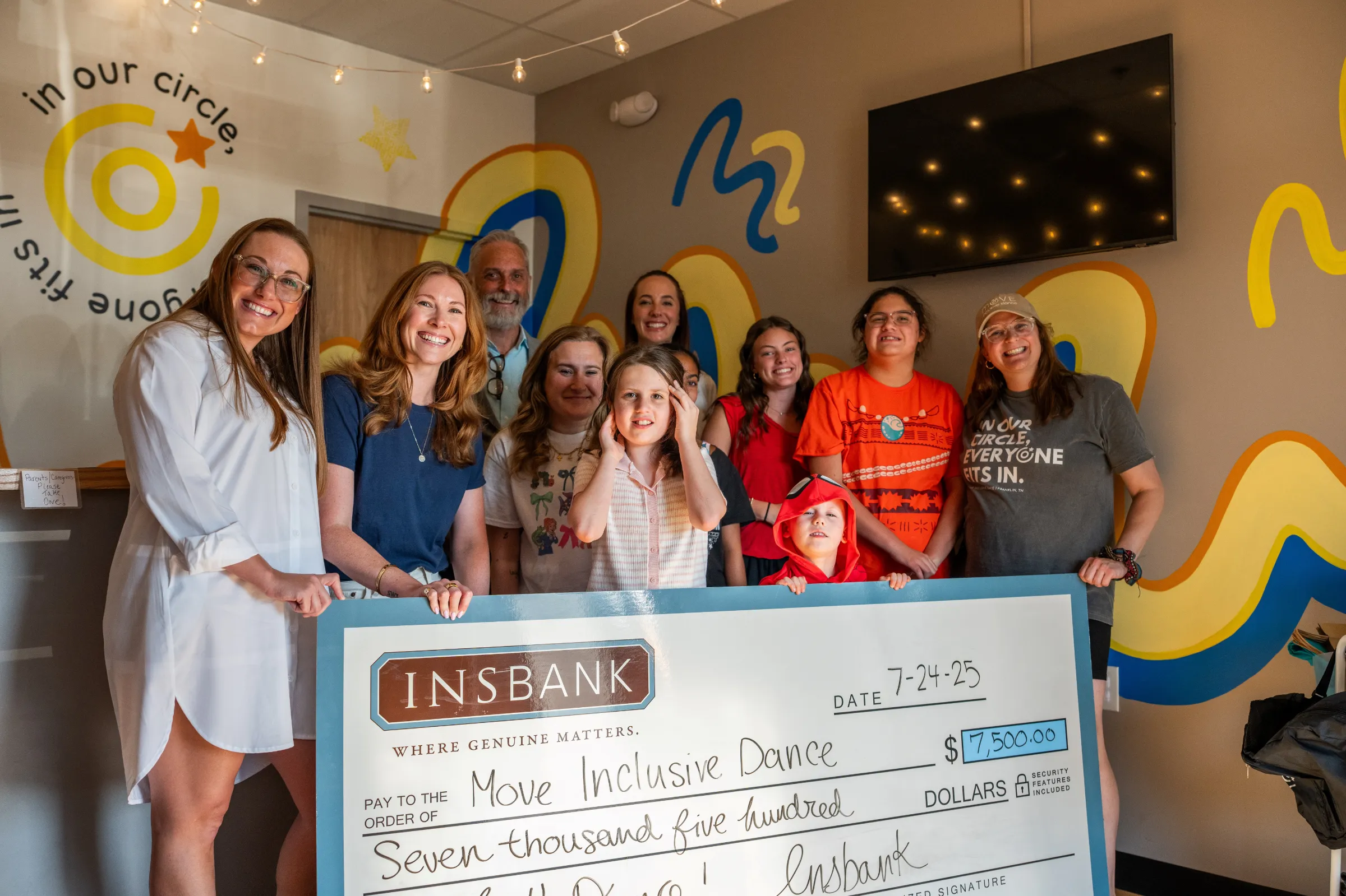 INSBANK awards a $7,500 check to Move Inclusive Dance in a group presentation