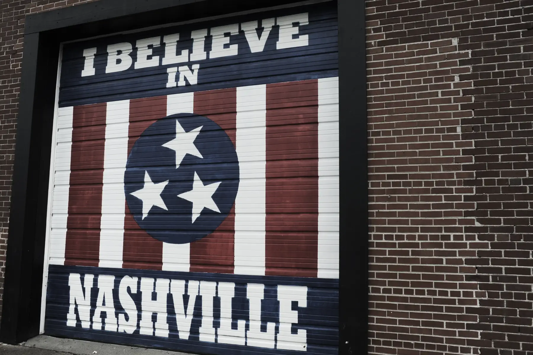 A commercial garage door with a mural