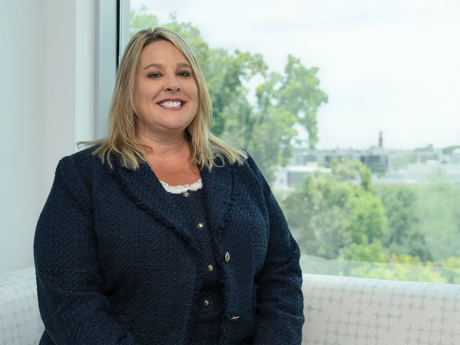 Sammie Mosier poses in front of a window