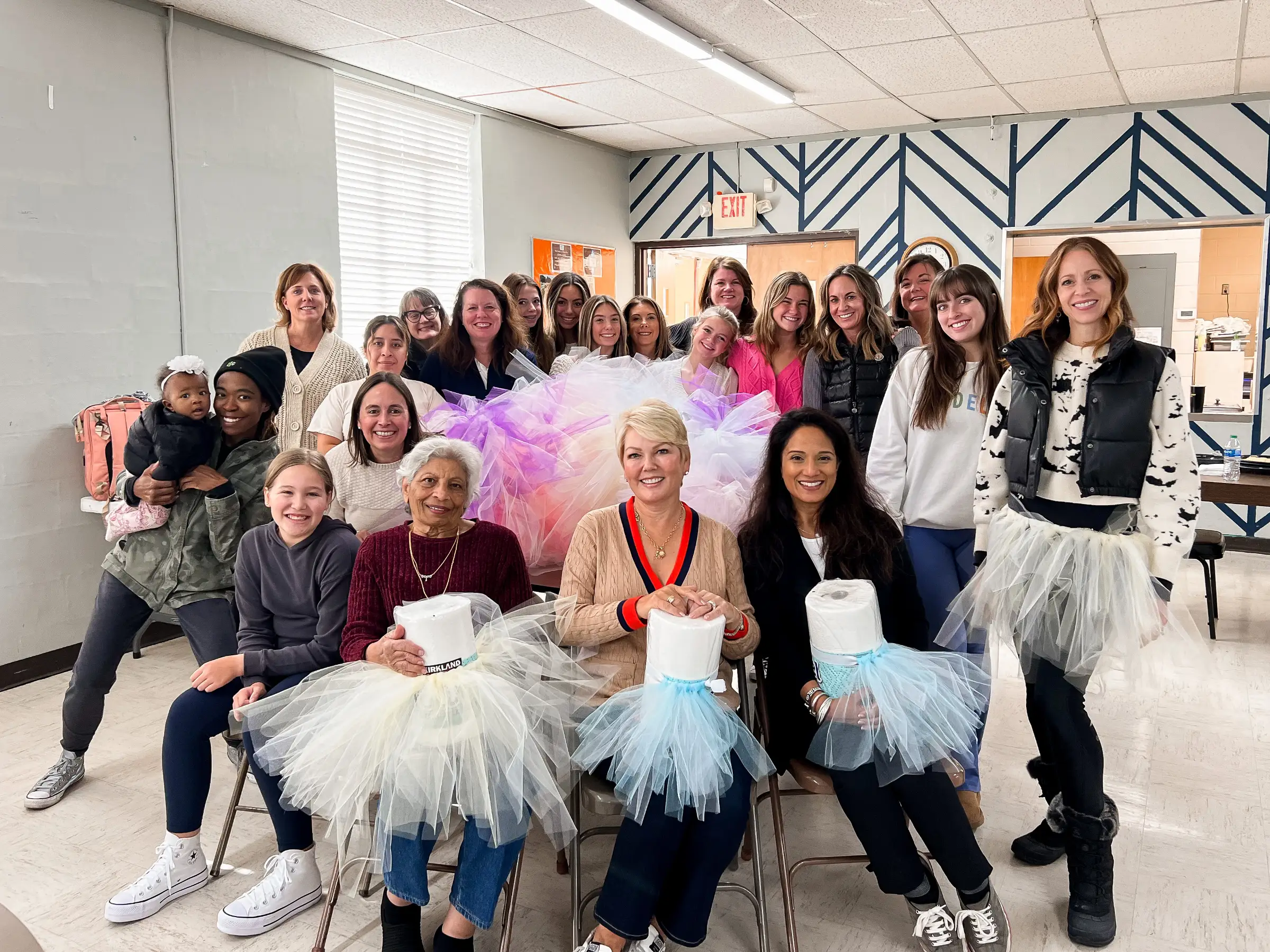 A group of women pose for a photo at a Girls Give volunteer meet-up event.