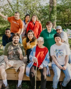 A diverse group poses for a photo at a group cookout, one of the many community events at Our Place