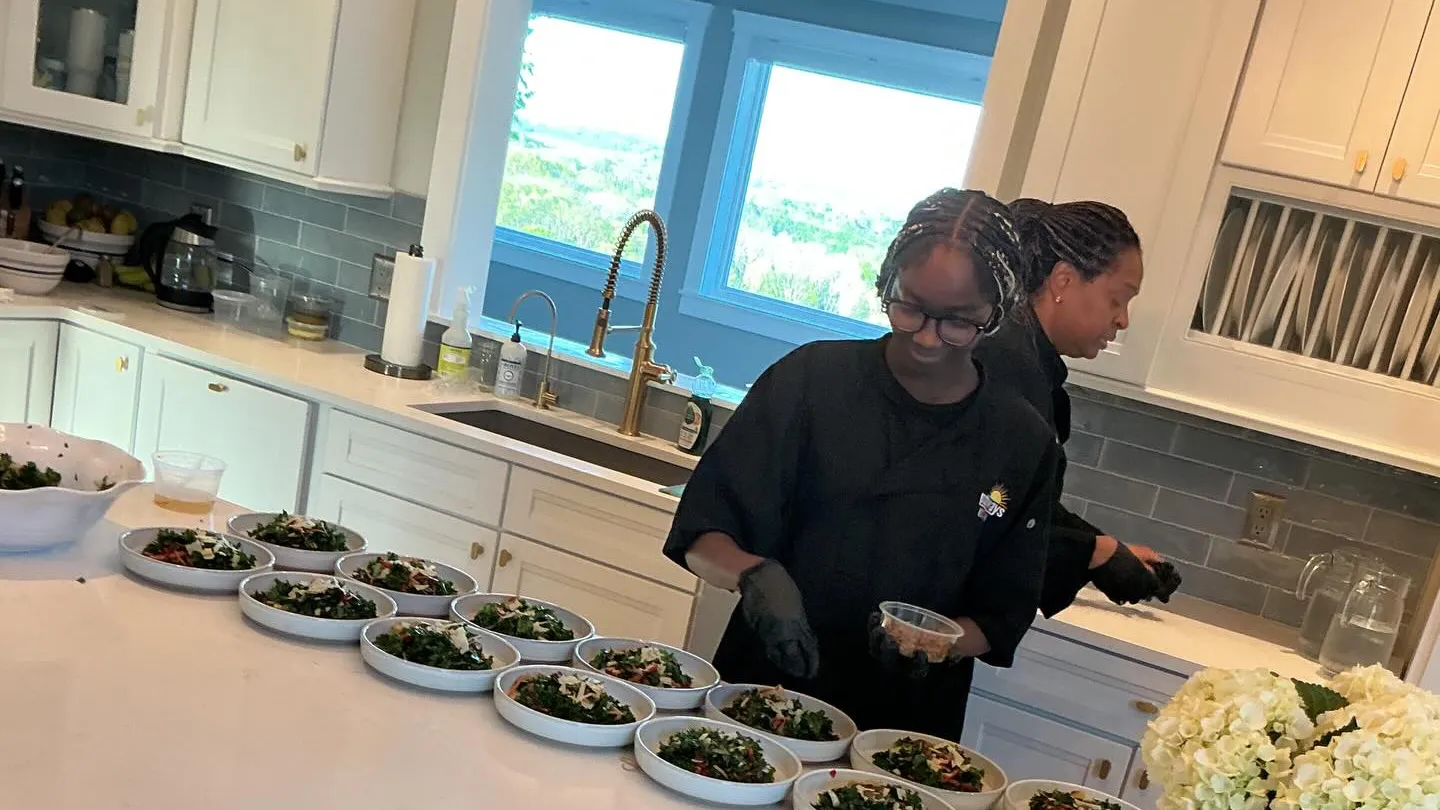 A Pathways participant and Pathway's Culinary Directory - Chef Lola - prepare a meal at an event.