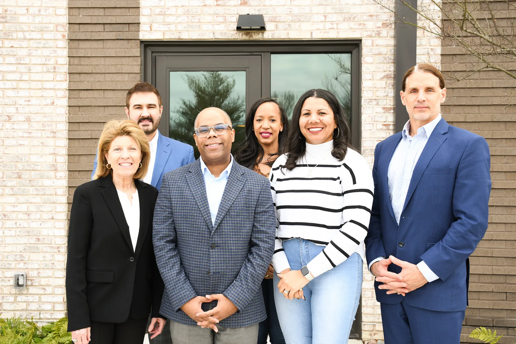 Past CFMT board members pose outside CFMT's new headquarters.