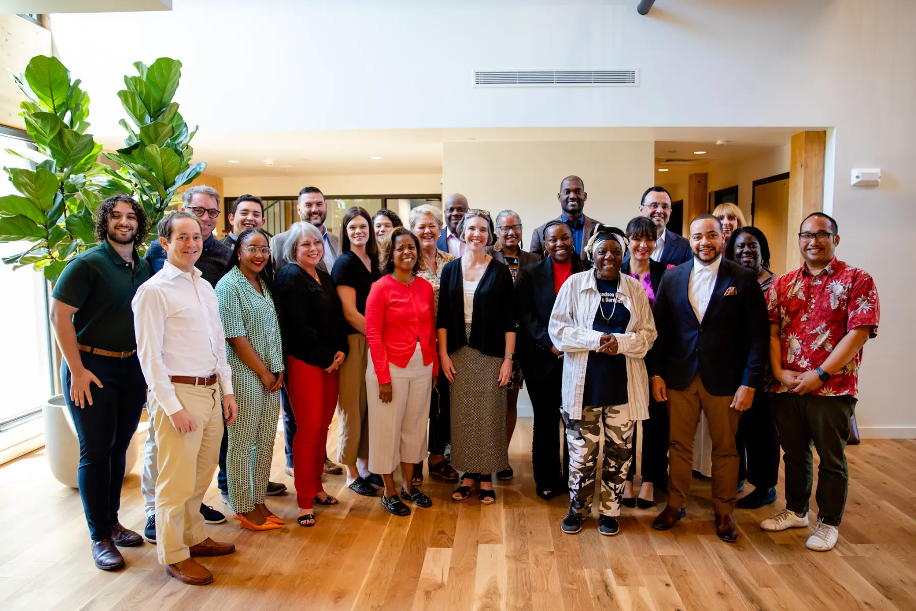 A nonprofit group poses for a photo in the CFMT lobby after utilizing one of the community meeting spaces.